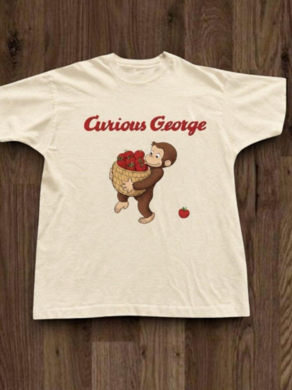 Monkey carrying a basket of apples white tee